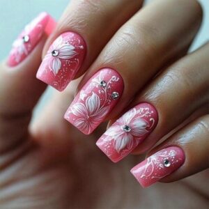 medium square pink press on nails with white floral patterns and small white diamond decorations