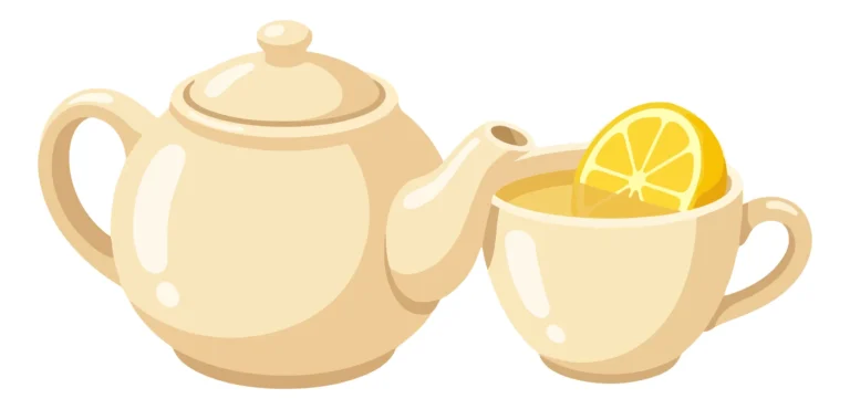 ceramic teapot and a cup of tea with a slice of lemon isolated on white background