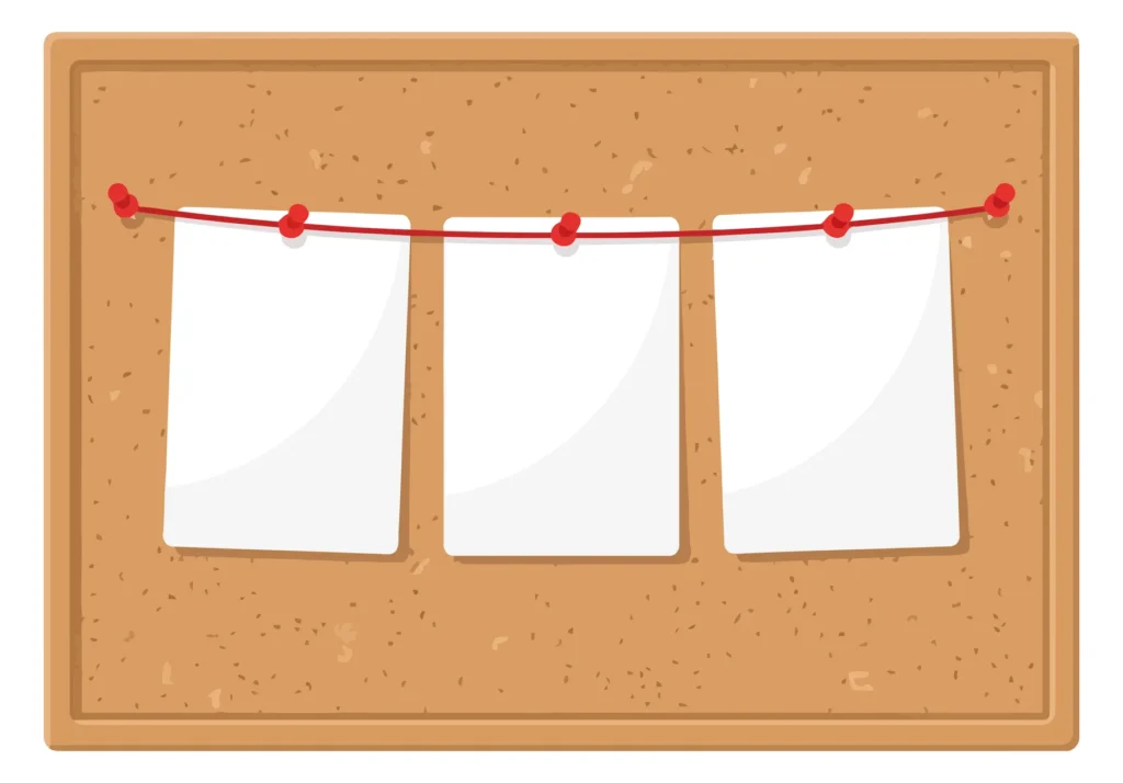 cork bulletin board with three blank paper notes