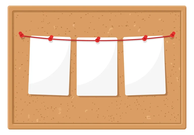 cork bulletin board with three blank paper notes