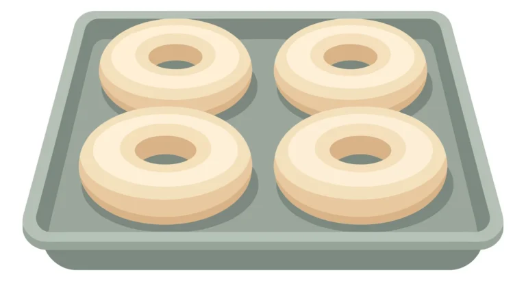 four raw dough donuts arranged on a rectangular metal baking sheet, topdown view of uncooked pastry rings ready for the oven, isolated vecto