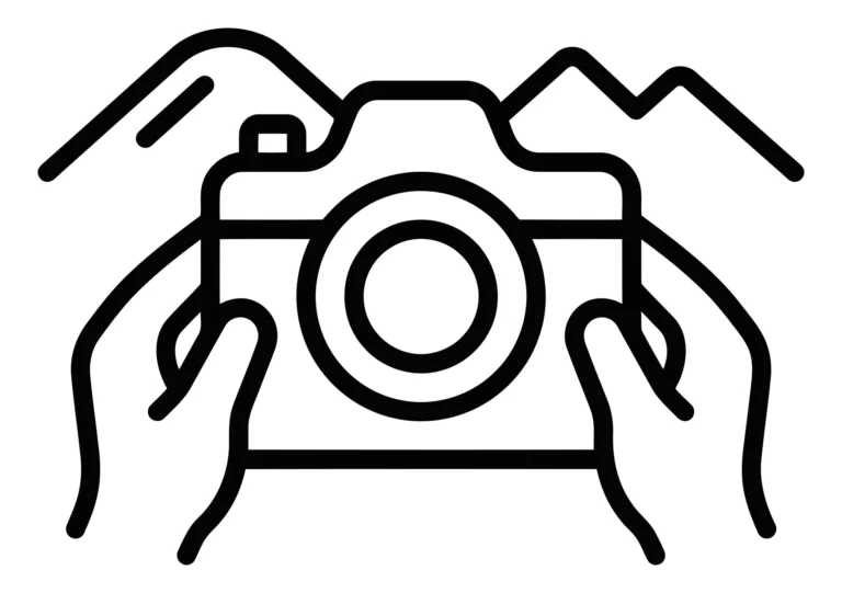 hands holding a camera with mountain landscape background