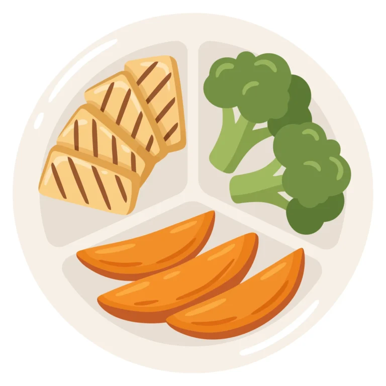 healthy meal on a divided plate with grilled tofu, broccoli, and potato wedges