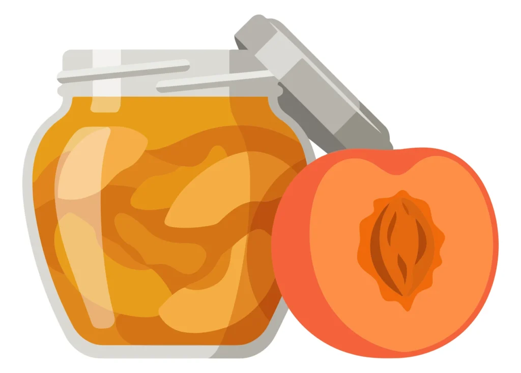 jar of peach jam with a halved peach next to it