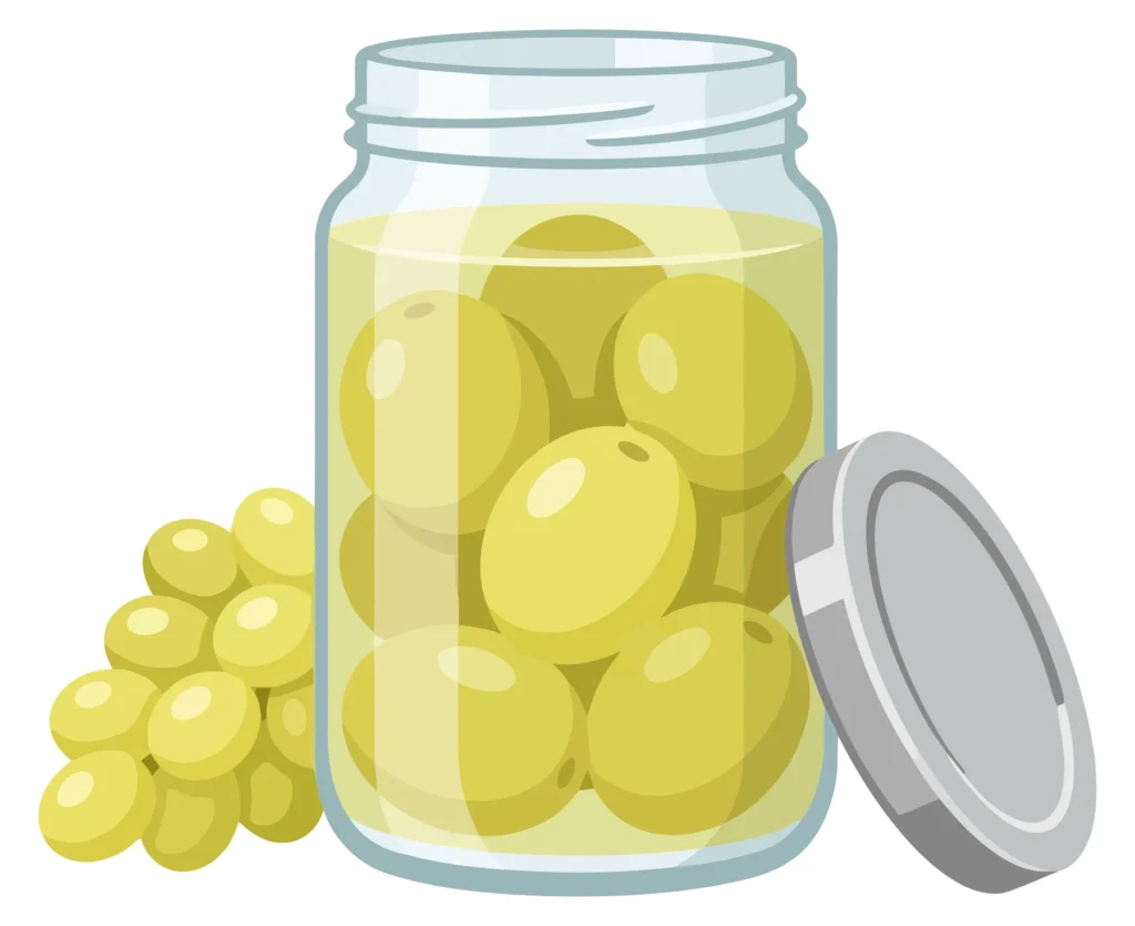 jar of pickled olives with a bunch of grapes next to it