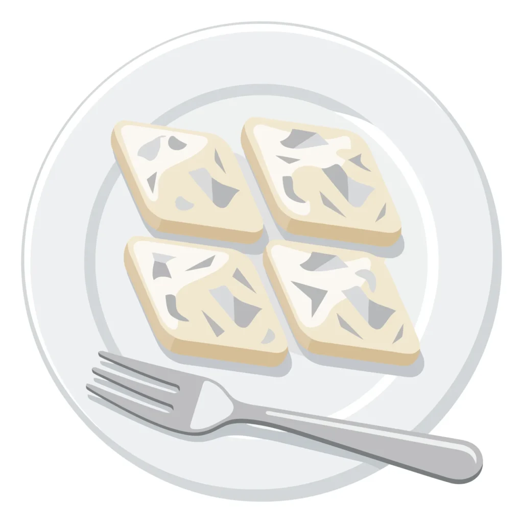 kaju katli indian sweet dessert served on a plate with a fork