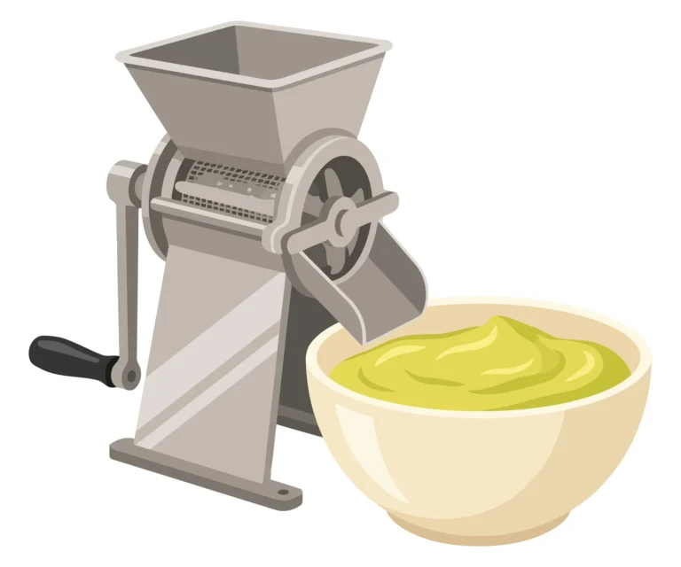 manual food mill with green puree in a bowl