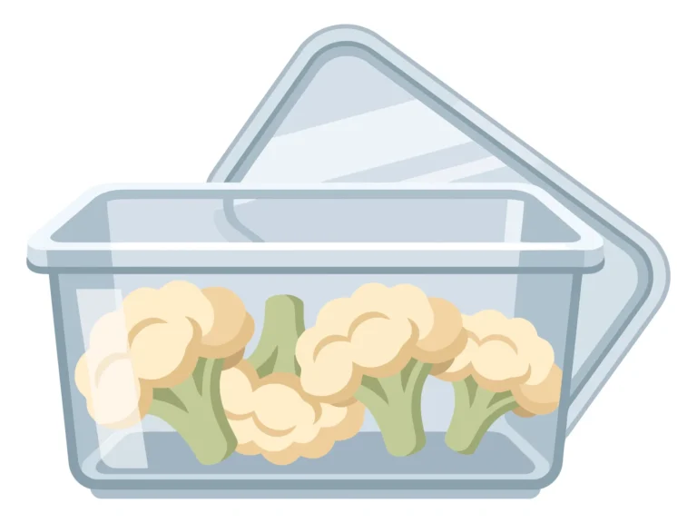 raw cauliflower florets stored in a clear plastic food container with the lid open isolated on white background