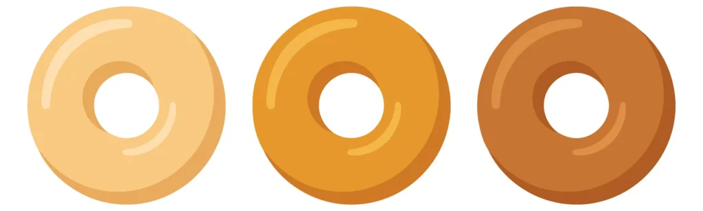 set of three glossy doughnuts in different shades of brown and beige isolated on white background
