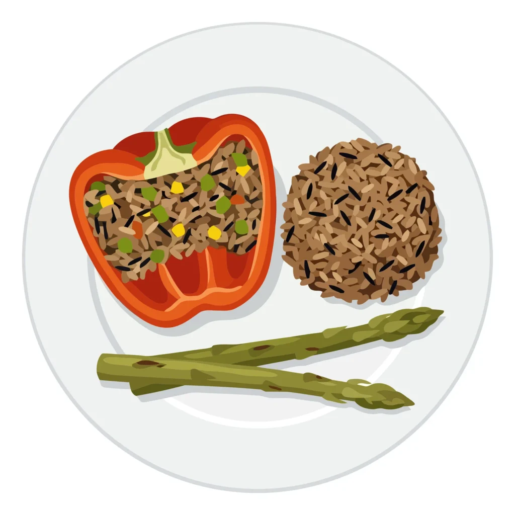 Stuffed Red Bell Pepper with Wild Rice and Asparagus stuffed red bell pepper with wild rice and asparagus spears on a plate