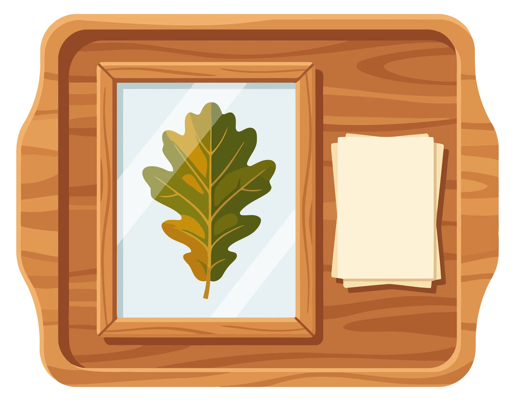 wooden tray with a framed oak leaf illustration and a stack of blank paper sheets, flat lay top view of a creative workspace or botanical ar