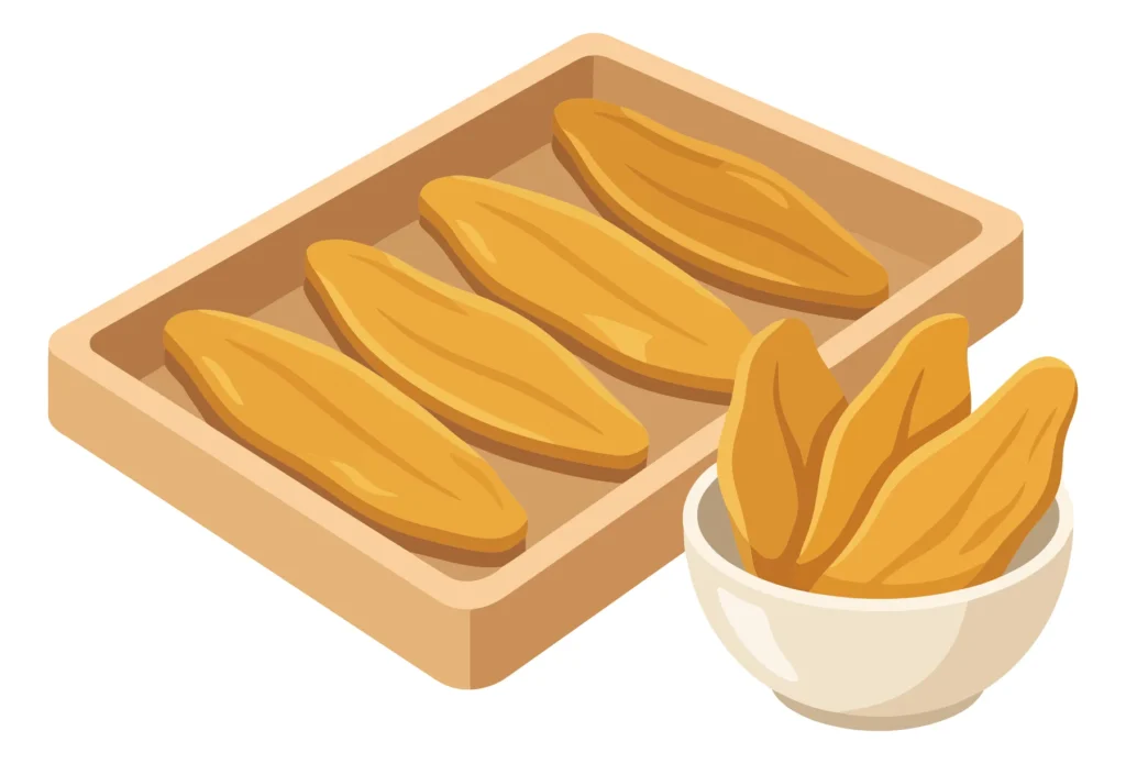 wooden tray with yellow dried mango slices and small bowl isolated on white background