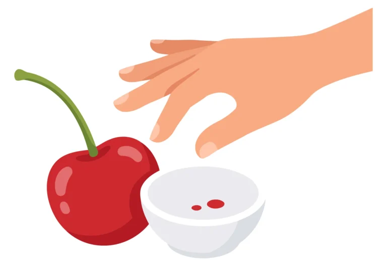 A hand picks a red cherry and places its seed into a bowl