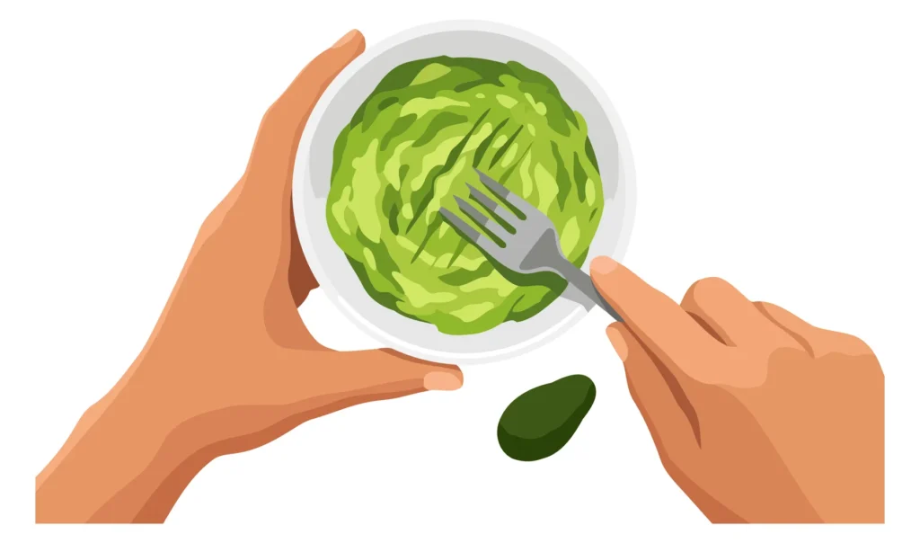 A hand holds a bowl of green salad with a fork and olive on a clean background