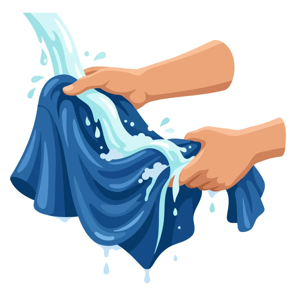 A pair of hands washing a blue fabric towel with water droplets