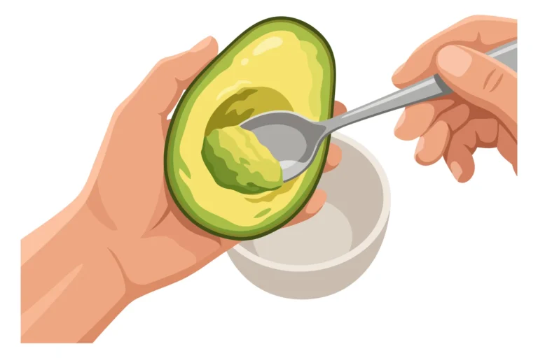 A hand scooping avocado seed with a spoon from an open avocado half in an illustration.