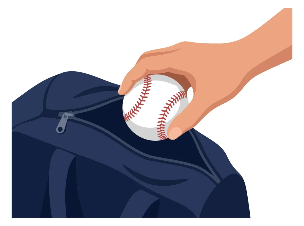 Hand holding a baseball inside a dark blue jacket pocket A hand holding a baseball inside a blue jacket pocket